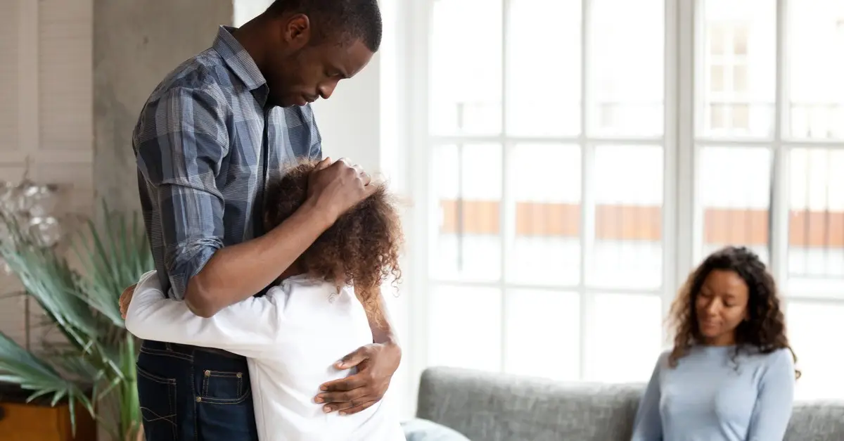Father hugs daughter